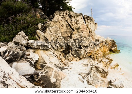 Saliara Beach (called Marble Beach), beautiful white beach in Thassos island, Greece. Landscape with water and rocks at sunset. Fish eye lens effects