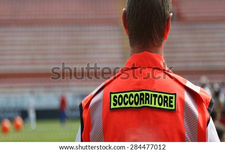 italian doctor with orange uniform at sporting event