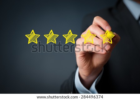 Increase rating, evaluation and classification concept. Businessman draw five yellow star to increase rating of his company. Royalty-Free Stock Photo #284496374