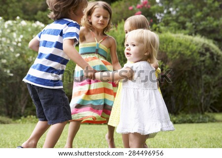 Group Of Children Playing Outdoors Together Royalty-Free Stock Photo #284496956