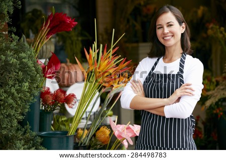 Portrait Of Female Florist Outside Shop Royalty-Free Stock Photo #284498783