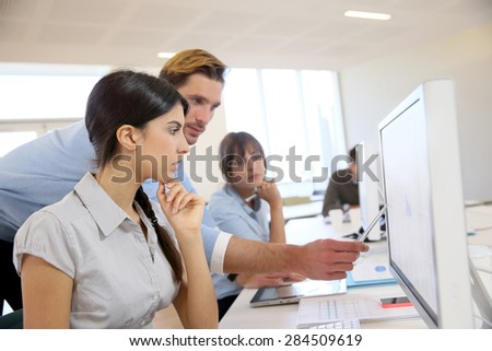 Business people working in office on desktop computer