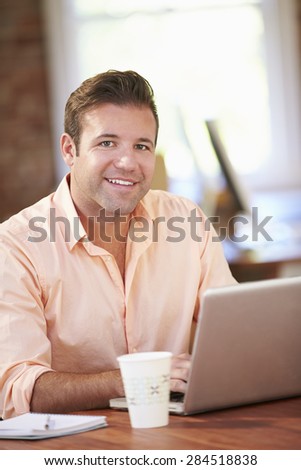 Man Working At Laptop In Contemporary Office