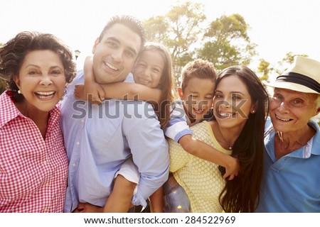 Multi Generation Family Having Fun In Garden Together Royalty-Free Stock Photo #284522969