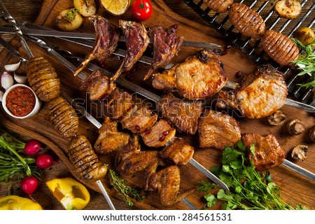 Kebab, chicken wings, potato on skewer. bbq meat, top view.
Grilled meat skewers, shish kebab on wooden background