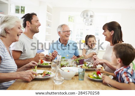 Multi Generation Family Eating Meal Around Kitchen Table Royalty-Free Stock Photo #284570258