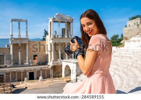 Young woman tourist photographing Roman theater of Philippopolis in Plovdiv, Bulgaria