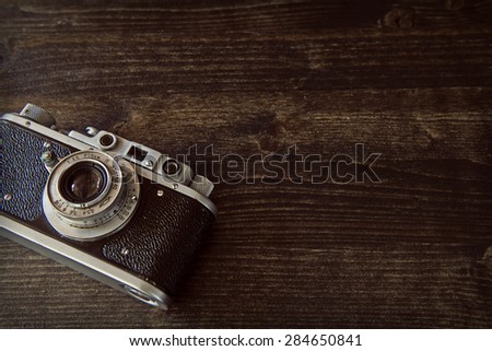 Ancient camera on a wooden background
