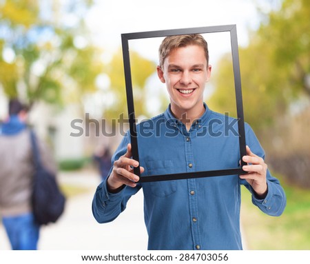 happy young-man  holding a black frame