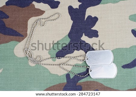 us army woodland  camouflaged uniform with blank dog tags background
