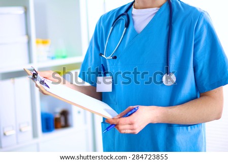 Closeup portrait of a  doctor with stethoscope holding folder
