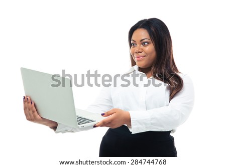 African businesswoman standing over white background and looking at laptop screen