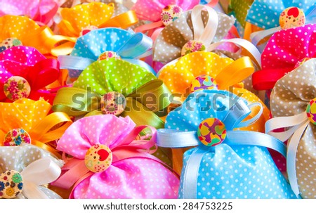 Many colorful gift bags with bow