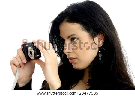 Half body view of attractive woman in elegant wear, taking a picture with a small camera. Isolated on white background.