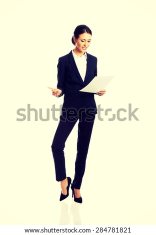 Happy businesswoman with paper notes.
