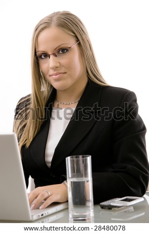 Young businesswomen working at desk using a laptop computer, isolated on white background.