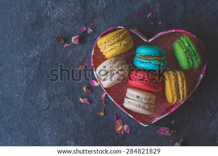 Sweet homemade macaroons cookies in heart shape box,selective focus and blank space