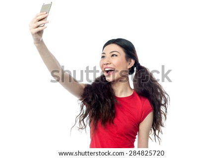 Cheerful woman taking a picture of herself