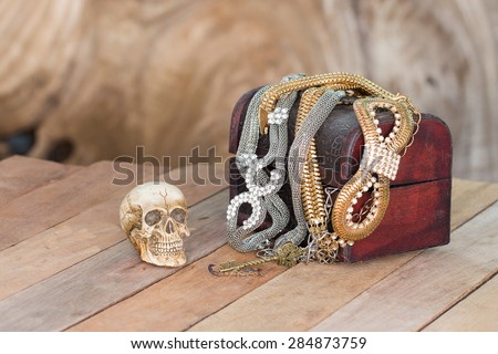 Still Life skull and small box with treasures on wooden  background