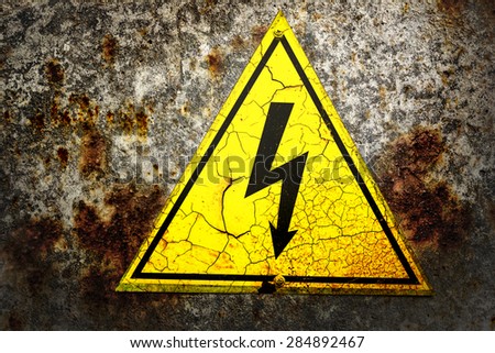 Old yellow sign with high voltage icon