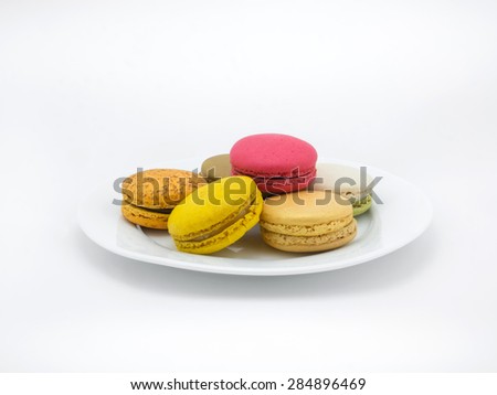 Colorful macarons on white plate and in white background