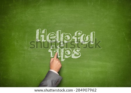 Helpful tips concept on green blackboard with businessman hand holding paper plane