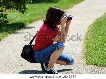 female photographer taking outdoor photos at a park