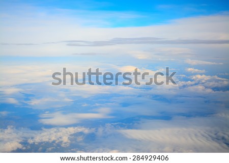 aerial view of a blue sky with white, soft clouds