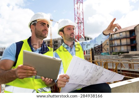 View of a Worker and architect watching some details on a construction Royalty-Free Stock Photo #284938166