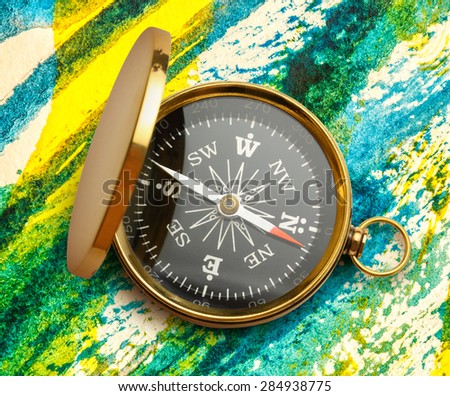 Golden vintage compass opened on watercolor background