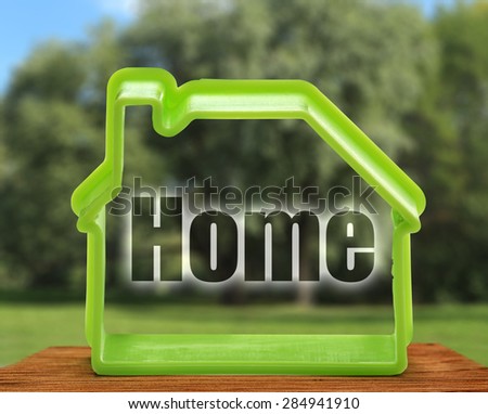 Toy house form as symbol on outdoors background