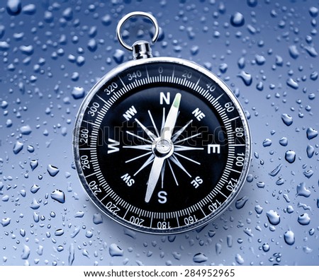 Black compass on the blue raindrop background