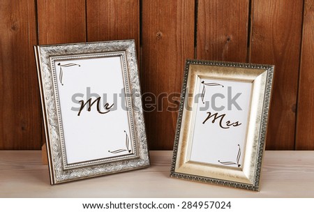 Photo frames on wooden surface, on wooden wall background