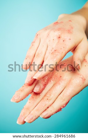 Female hands in body scrub on blue background