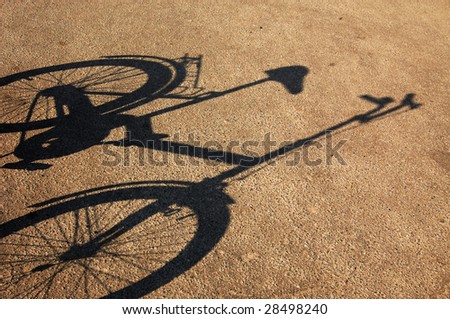 Shade of a bicycle on a cracked asphalt. Royalty-Free Stock Photo #28498240