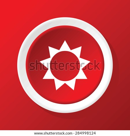 Round white icon with image of sun, on red background