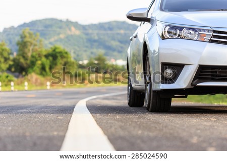 Close up front of new silver car parking on the asphalt road Royalty-Free Stock Photo #285024590