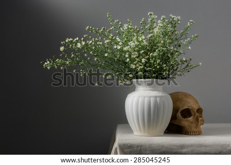Still life with flowers in vase and skull