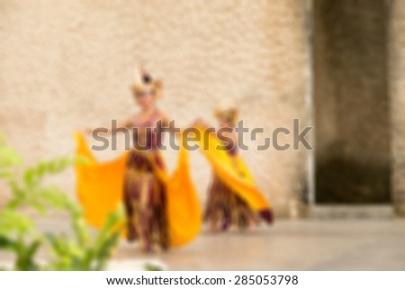 Traditional Bali dance performance blur background with shallow depth of field bokeh effect
