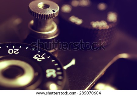 Old film DSLR camera. The wheel of choice shutter and shutter button. Close up view. Macro. Selective focus. Vintage photo. Toning.