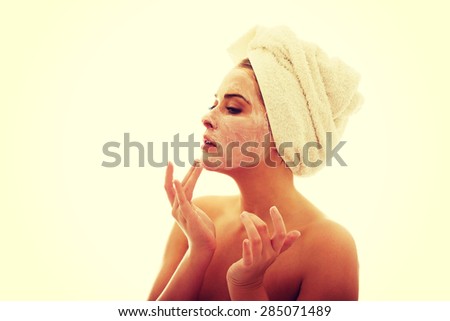 Woman applying a cream on her face.