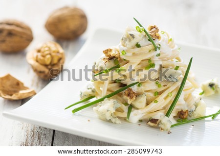     Pasta with gorgonzola on a wooden background 