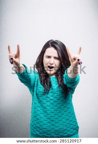 young woman shows a sign of rock