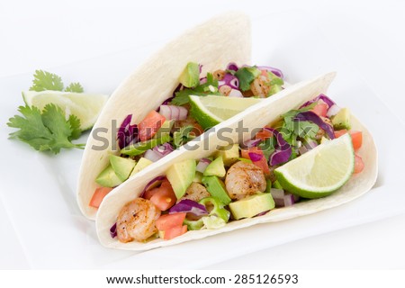 High resolution two spicy shrimp taco with avocado, tomato and red onion cilantro
