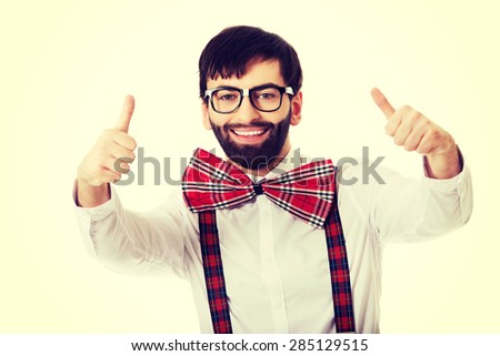 Funny handsome man wearing suspenders with ok sign.