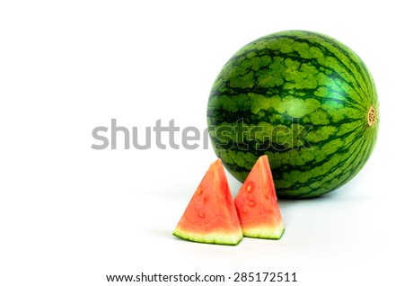 A watermelon with a slice cuts isolated on white background. Copy space.