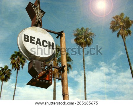 aged and worn vintage photo of beach sign with palm trees                             