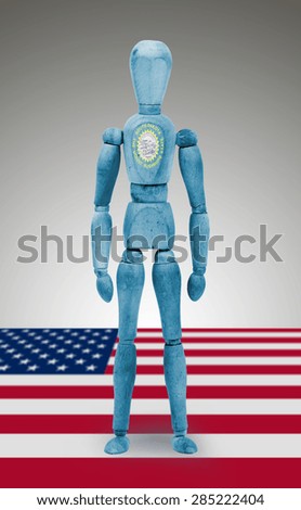 Old wood figure mannequin with US state flag bodypaint - South Dakota