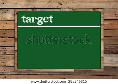 'target' write on Green board on wood background