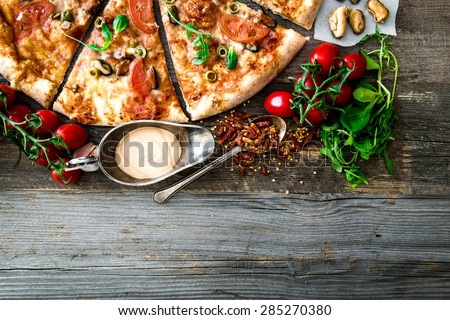 Tasty seafood pizza with cherries on a wooden table